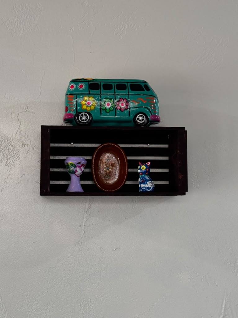 Wall shelf with a hand-painted VW bus and Mexican folk-art figures
