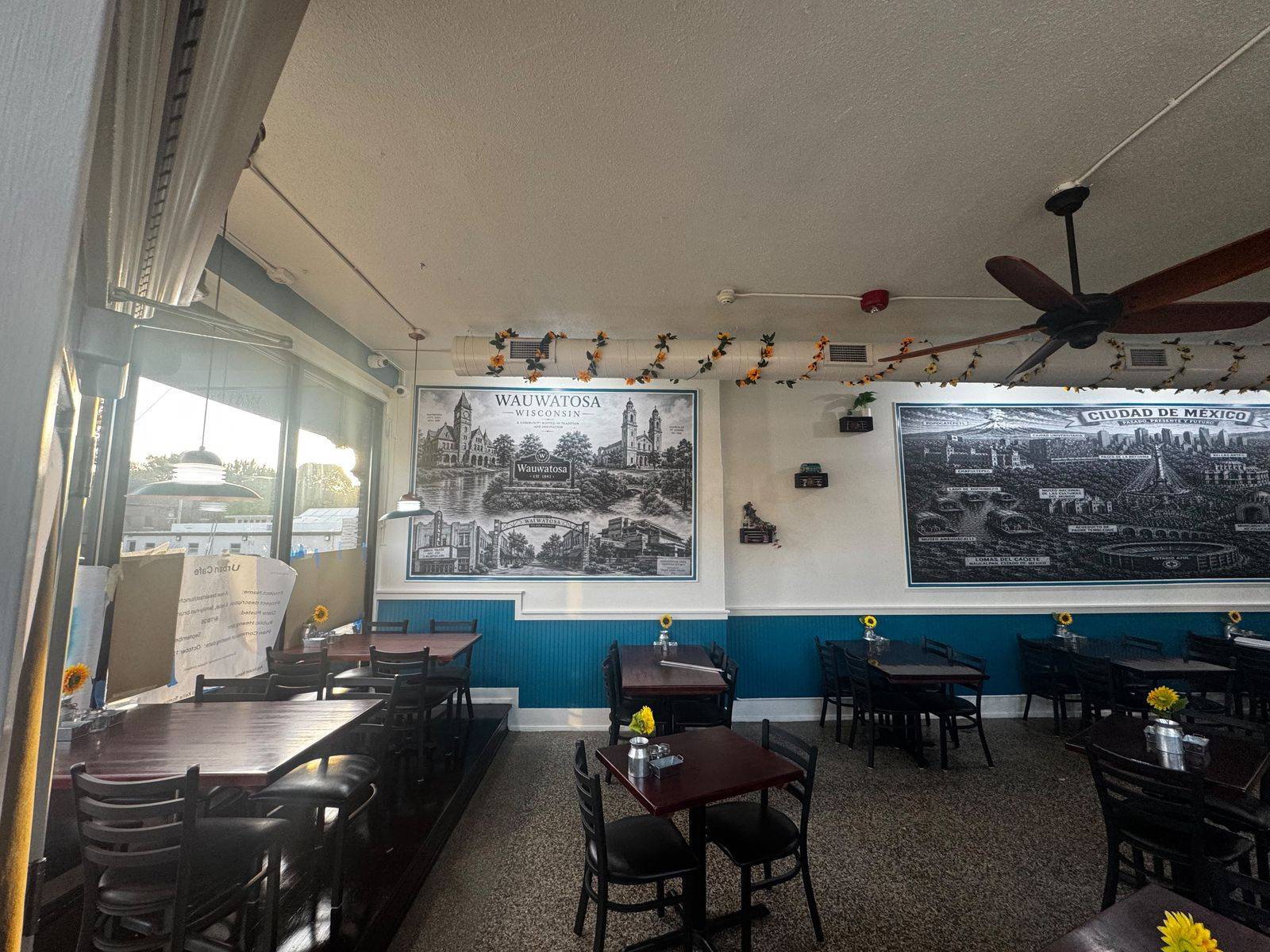 Dining room by the front windows with the Wauwatosa mural